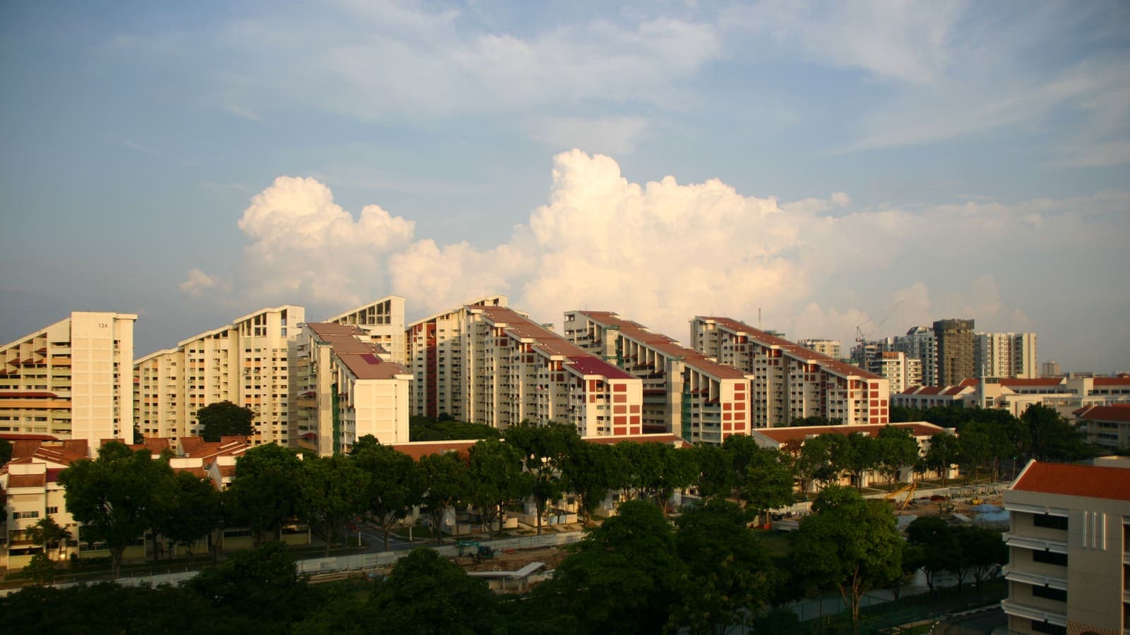 The stepped roofs of Potong Pasir's HDB blocks at sunset